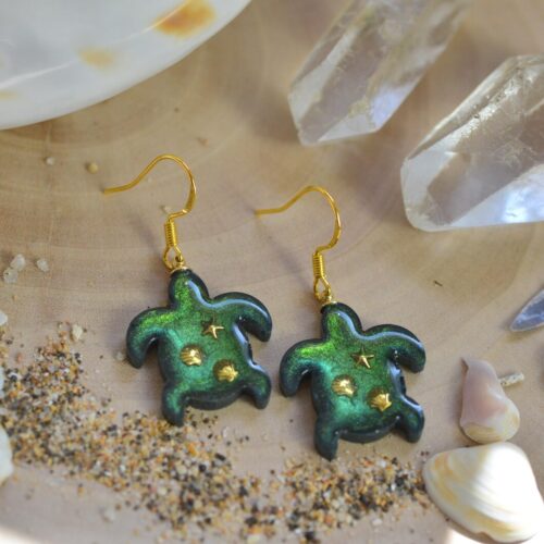 pair of turquoise turtle earrings on the table