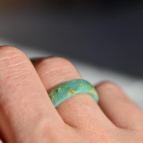 hand waring green resin ring