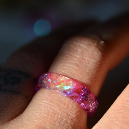 Finger wearing pink aurora resin ring